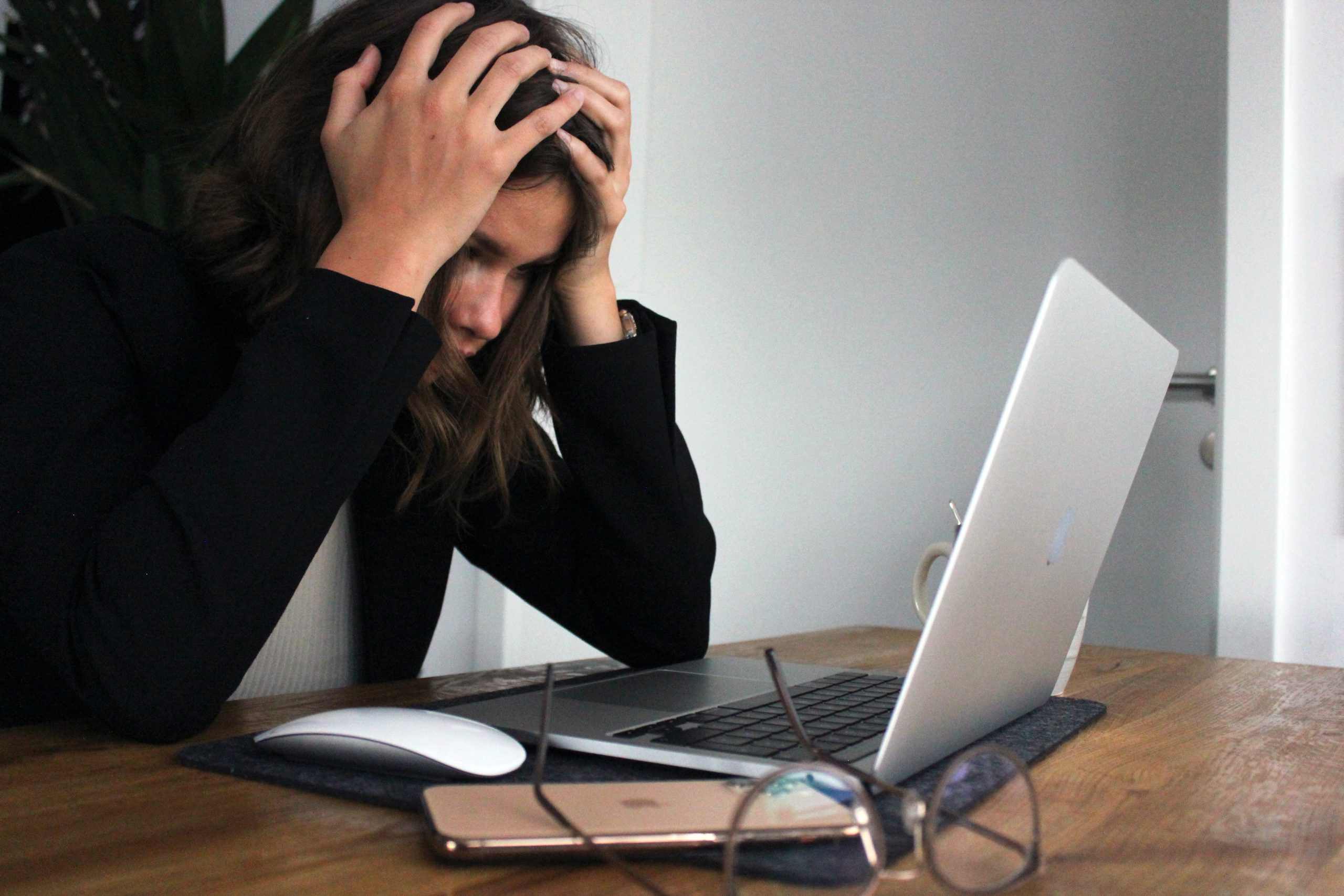 A woman on her computer frustrated whilst deploying Power Automate flows to SharePoint